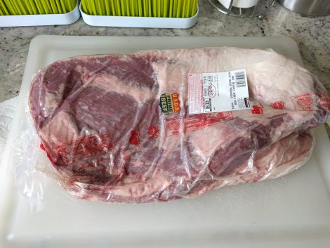 Meat pressed against the plastic wrap